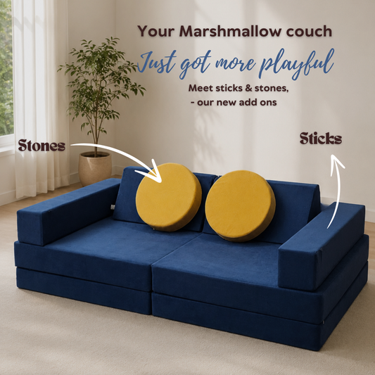 A light blue modular foam play couch shaped like a car, styled in a warm, modern children's room with wooden floors, a beige rug, and toys.